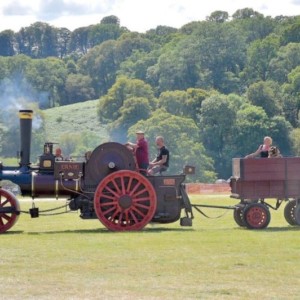 a photo of a steam engine pulling a trailer 