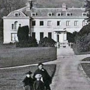 old photograph of boconnoc house with some victorian people in the foreground