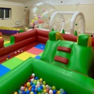 photograph of a soft play set up including ball crawl and slide